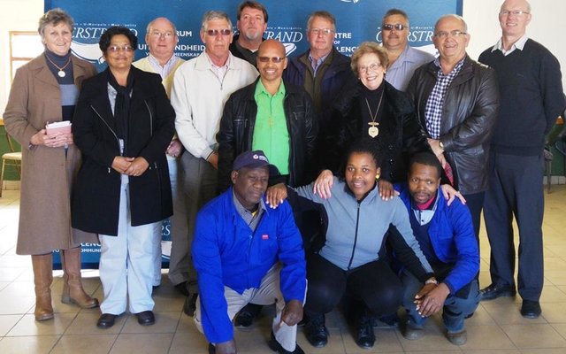 Fltr:  Cllr Lisel Krige, Cllr Moira Opperman, Cllr Dudley Coetzee, Ald Phillipus Appelgrein, Koos Du Plessie, Cllr Rudolph Smith, (Overstrand Deputy Mayor), Abrie Hickman (Adenco), Ald Nicolette Botha-Guthrie (Overstrand Mayor), Danie Fourie (Auricon) Coenie Groenewald (Overstrand Municipal Manager), Stephen Muller (Dir Infrastructure and Planning). Sitting: Mlindeni Mkrabalala, Noluvuyo Qobani and Ntobeko Msheqo (community members)